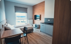 Studio room, table and bed in background