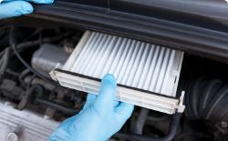 Hand of mechanic replacing filter 