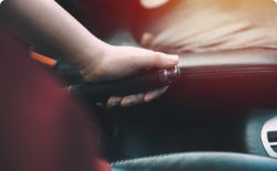 Hand of mechanic during handbrake cable replacement